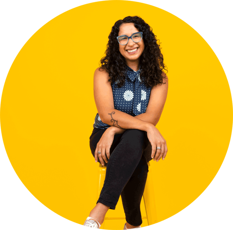 Cristina Florencia Castro smiling against a bright yellow background